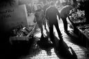 A woman walks among the group of pedestrians at the street