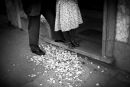 Man and a girl stand in flower carpet at the house threshold, Braga, Portugal