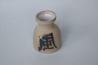 Vase with wind symbol