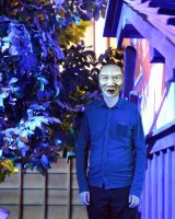 A Neanderthal man under a blue tree