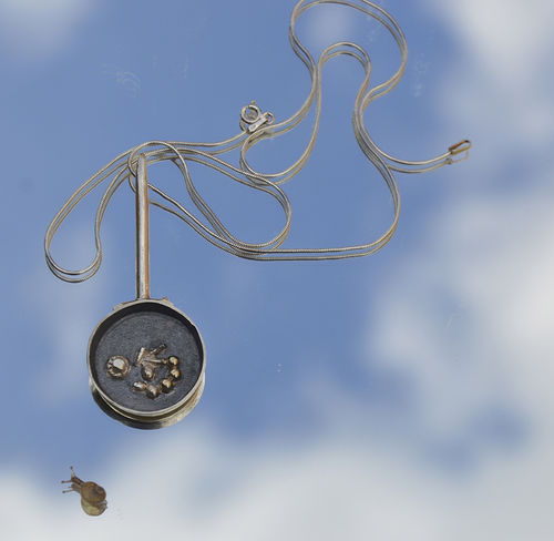Sterling silver frying pan with mushroom, beans and gold potatoes.