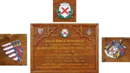 A carved oak memorial plaque