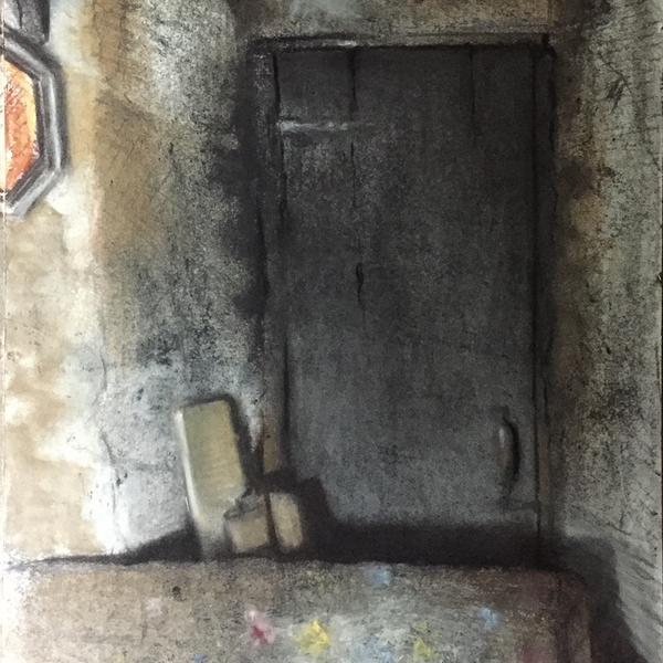 An ornate old sofa in front of a recessed door in the corner of a dark room in an empty house.