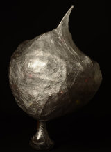 A dead Christmas tree with baubles wrapped in cling film.