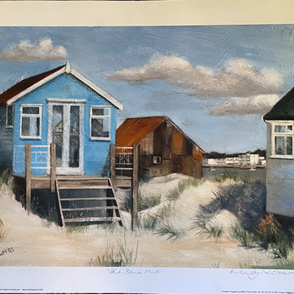 Print of a blue beach hut on Mudeford Sandbank Spit with a view of Christchurch behind