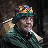 Bric a Brac Seller in the Rain by John Tilsley