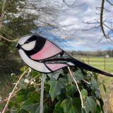 mosaic long tailed tits on a garden stake